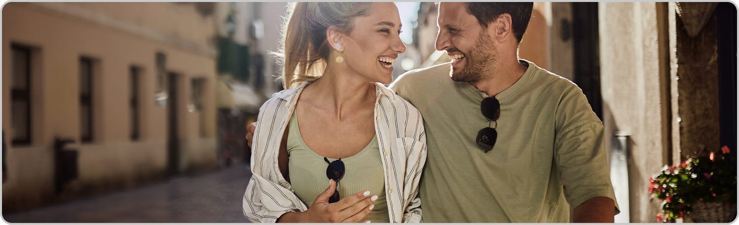 Stock picture of a couple laughing and walking together.